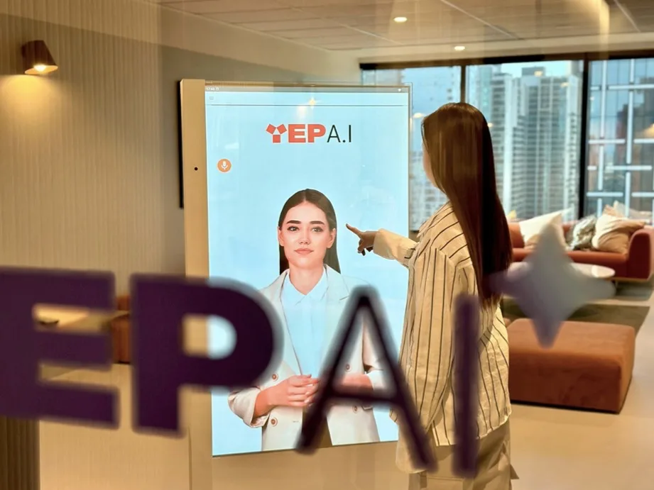 A visitor talking to a Yep AI Digital Human on a screen in the Yep AI office